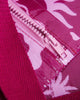 A small zippered pouch with a maroon wrist strap, featuring a palm tree and sun mixed pattern of bright pink shapes on a maroon colour. A small fabric tag on the right reads Hello Weekend. Layla Print - Phone Pouch - Reusable bags online | Daily bags | Shopper bags | Weekender bags  Hello Weekend