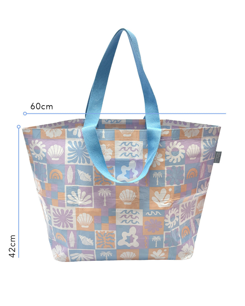 A Hello Weekend large bag with a pastel patchwork pattern featuring beach motifs like seashells, palm trees, and waves in lavender, blue, orange, and white, with light blue handles. Lizzie Print - Weekender Bag - Reusable bags online | Daily bags | Shopper bags | Pouches  Hello Weekend Beige canvas handles | Beach Bags
