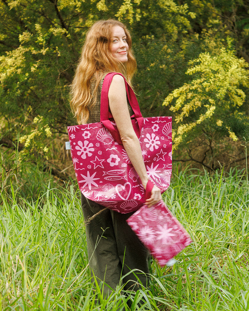 A Hello Weekend magenta tote bag with a pink and white ocean-themed pattern featuring seashells, starfish, waves, and a heart with two sets of maroon cotton canvas straps. Layla Print - Weekender Bag - Reusable bags online | Daily bags | Shopper bags | Pouches  Hello Weekend Beige canvas handles | Beach Bags
